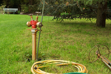 watering hose and hydrant in the garden