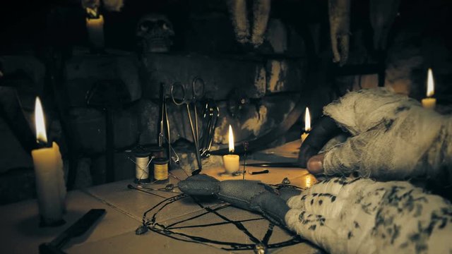 the mage conducts a ritual with the voodoo doll