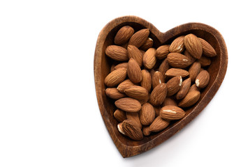 Top view dried almond in wood bowl on white background.