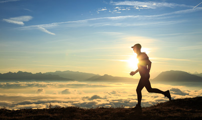 Fototapeta premium Athlete trailrunning in the mountains during a nice sunrise.