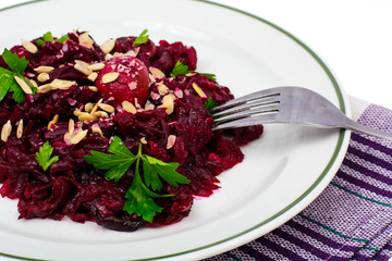White plate with snack of beet and seeds