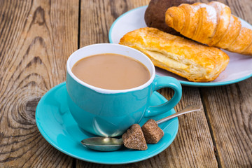 Coffee with milk, fresh pastry for breakfast.