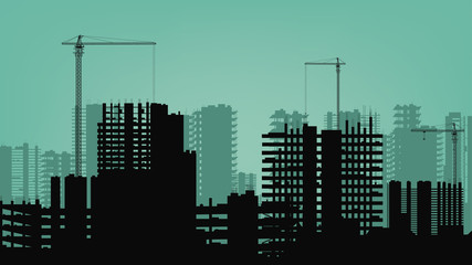 Buildings under construction and building cranes.