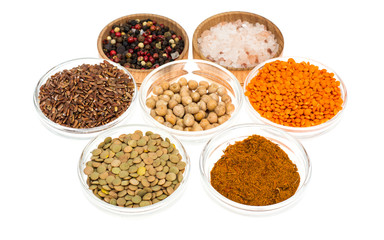 Different  bowls with spices, cereals and herbs on white background