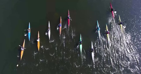 Air view: children are kayaking along the lake