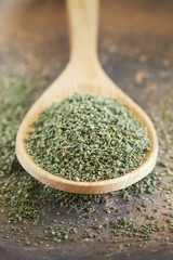 Stinging nettle (Urtica dioica) seeds in wooden spoon