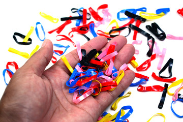 the color rubber band in hand on white background isolated