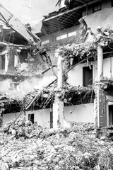 Demolishing a building with hydraulic crusher