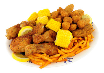 Plate of Southern fried chicken products with sweetcorn and fries
