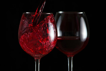 Beautiful splash of red wine in a glass