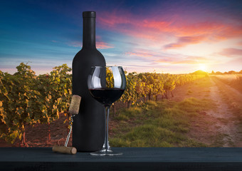 Red wine with barrel on vineyard in green Tuscany, Italy