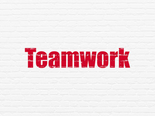 Business concept: Teamwork on wall background