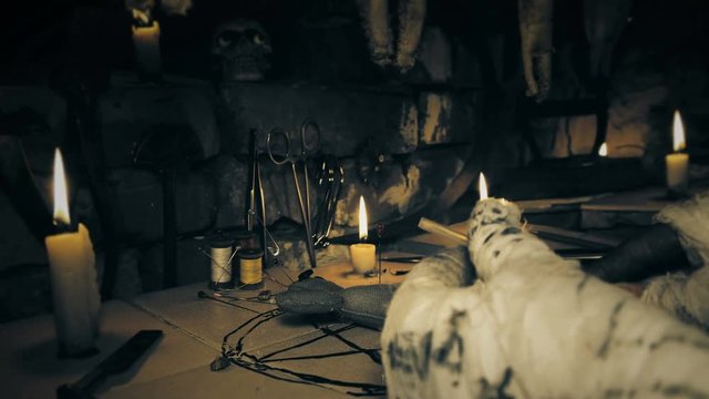the mage conducts a ritual with the voodoo doll