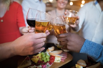 Close-up of friends toasting drinks