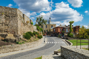 Historical district of the Kamianets-Podilskyi city near Kamianets-Podilskyi Castle: old houses and cobblestone pavement leading to the fortress, Ukraine