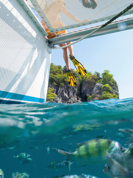 Legs of woman dangling from yacht, Koh Pak Ka, Krabi, Thailand, Asia