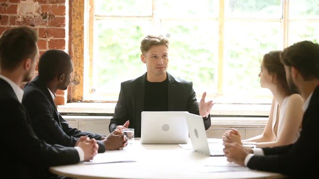 Company executive communicates with team at group meeting, boss talks to subordinates giving instructions, delegates work assigning tasks at briefing, ceo explains new strategy to diverse employees