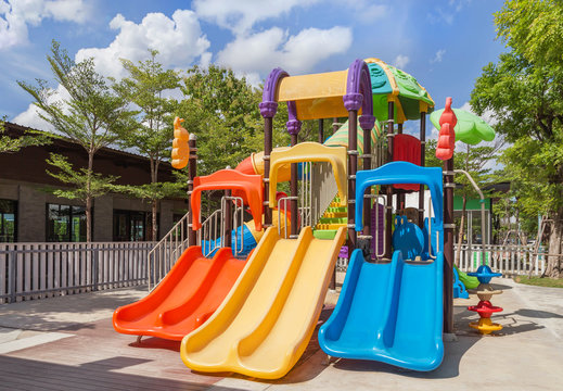 Colorful modern children playground in the park with blue sky background