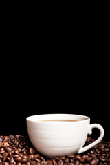 Coffee cup on coffee beans in close up photo. Refreshing beverage in the morning