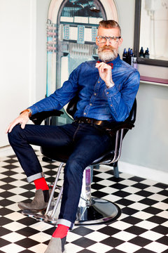 Barber in chair in quirky hair salon