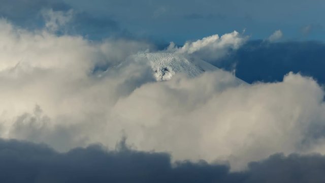 Volcanic landscape of Kamchatka Peninsula (time lapse): top of cone of active Avacha Volcano, fumaroles activity of volcano - steam and gas plume from crater, clouds drifting across sky near volcano.