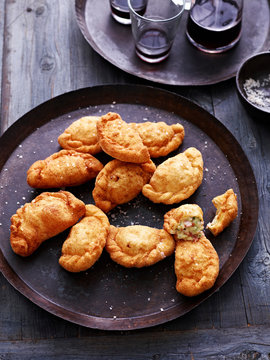 Deep fried calzone on serving plate, elevated view