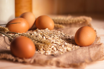 oat flakes, eggs and wheat ears on the table