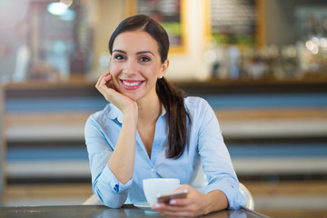 Woman with coffee and smart phone
