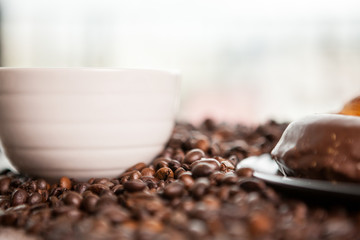 Coffee cup on coffee beans in close up photo. Refreshing beverage in the morning