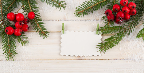 Fototapeta na wymiar Christmas fir tree and blank paper on white wooden background