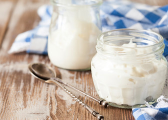 Fresh natural homemade yogurt on rustic wooden background