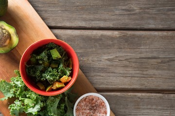 Fresh vegetable with cutting board at wooden table