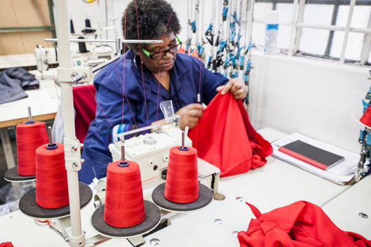 Seamstress working on overlocker in factory, Cape Town, South Africa