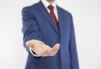 Businessman with open hand. Holding, giving, showing concept.