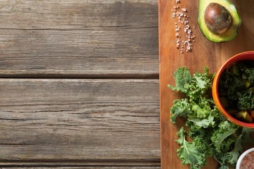 Fototapeta na wymiar Kale with avocado and rock salt on cutting board