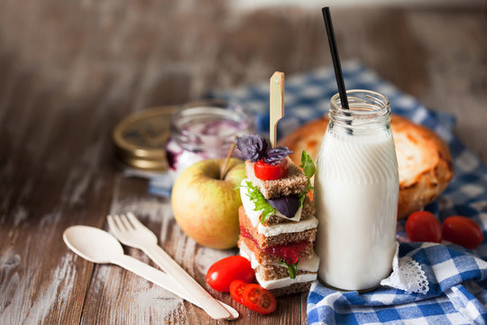 Healthy School Lunch With A Sandwich, Fresh Fruits, Bun And Milk