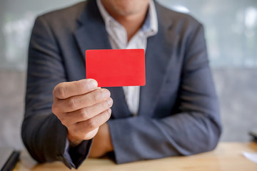 Businessmen holding red credit card
