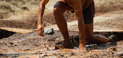 Mud race runners obstacle race runner in action