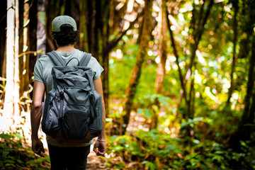 Man traveler traveling walking with backpack at the jungle on holiday at weekend on background nature view