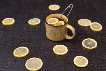 Obraz na płótnie Canvas Lemon tea on a black background