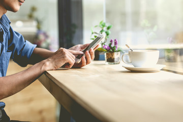 Man using mobile smartphone in the coffee shop