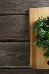 Kale leaves on wooden board