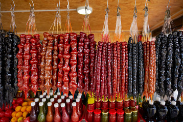 Wide range of Colorful Georgian traditional homemade sausage-shaped churchkhela candy on sale in small street market shop