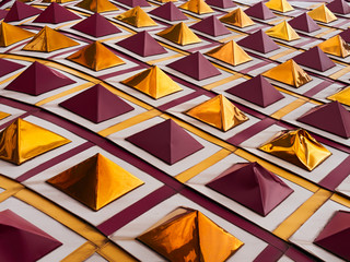 Perspective golden and dark red pyramid roof tiles pattern