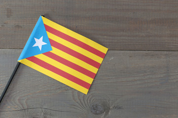 Fototapeta na wymiar A flag of Catalonia on a wooden background. 