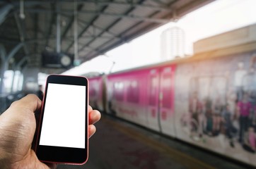 hand using smart phone isolated blank screen with blurred image of subway at railway station, people lifestyle, transportation, technology, internet, network connection, social media concept