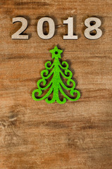Green Christmas tree and sign New year from wooden letters, symbol of wooden texture background. Happy new year 2018 backdrop. New year.Greeting card.