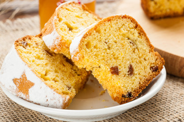 homemade traditional fruit cake slices at white plate  on wooden table