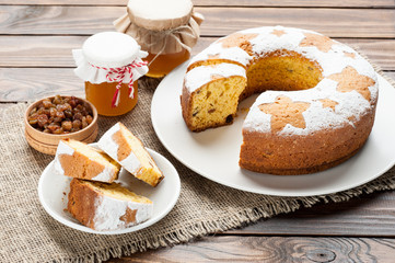 homemade traditional fruit cake slices on white plate  at wooden table