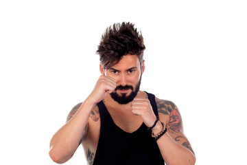 Handsome bearded man with tattoos showing the fists